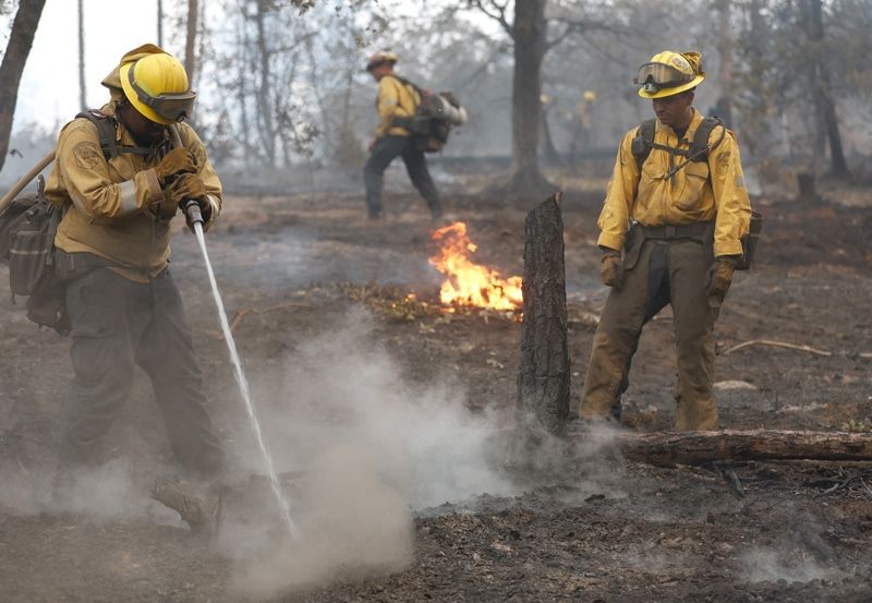 As a heat wave sweeps throughout the United States, firefighters battle a wildfire in California